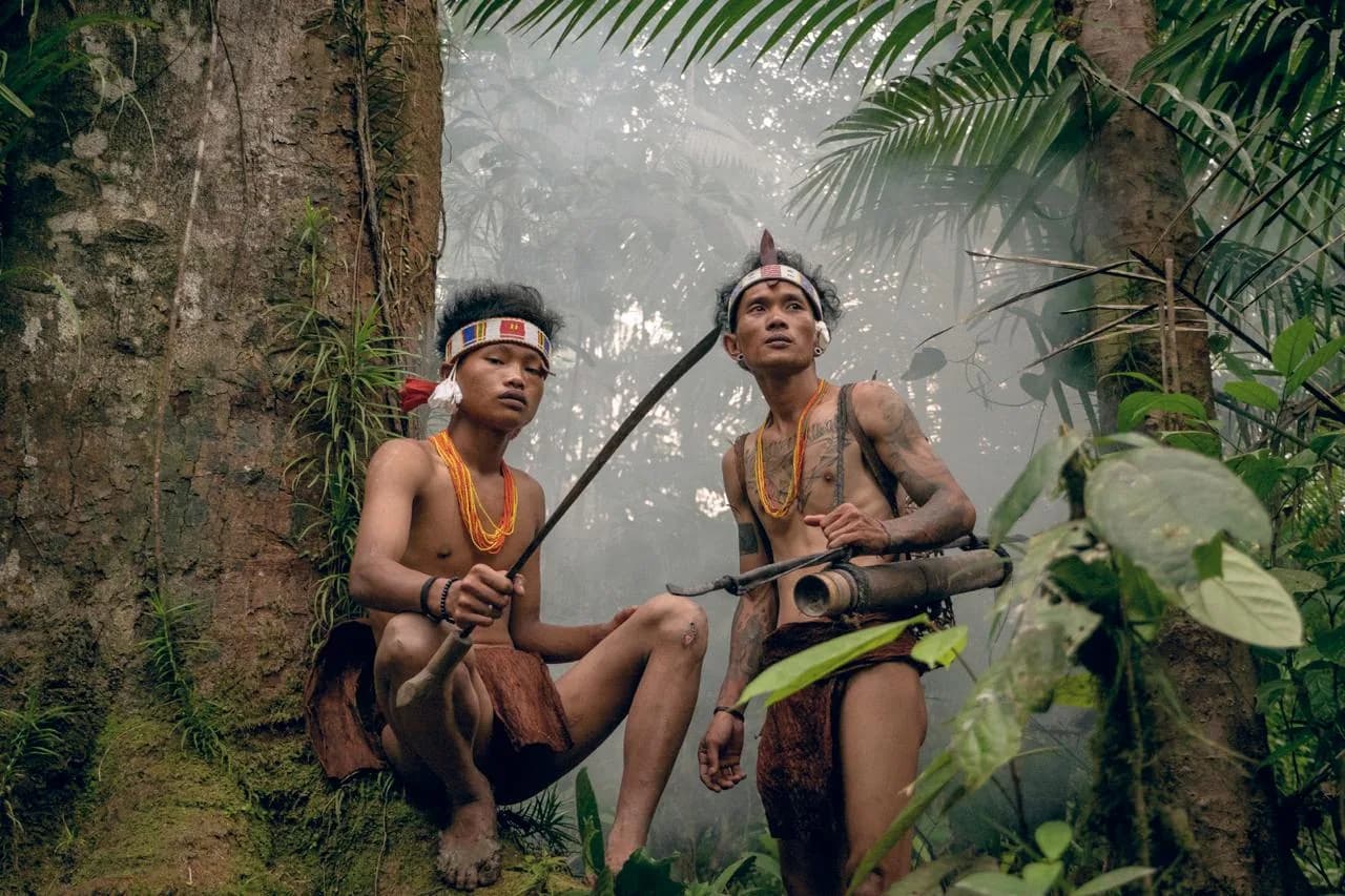 Mentawai guides walking through the rainforest