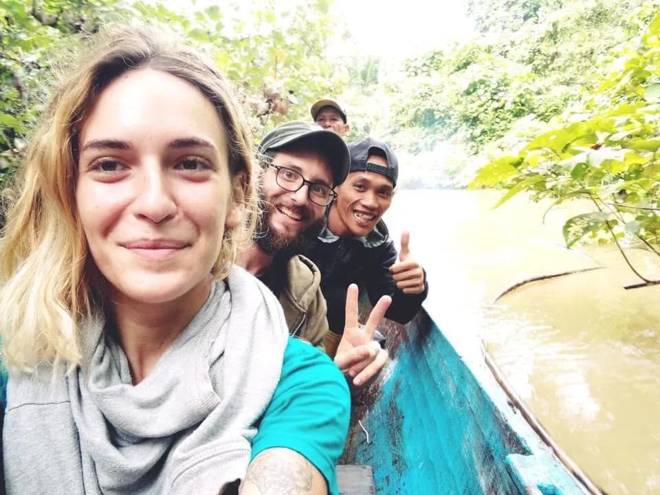 Guests traveling by canoe along a river in Siberut