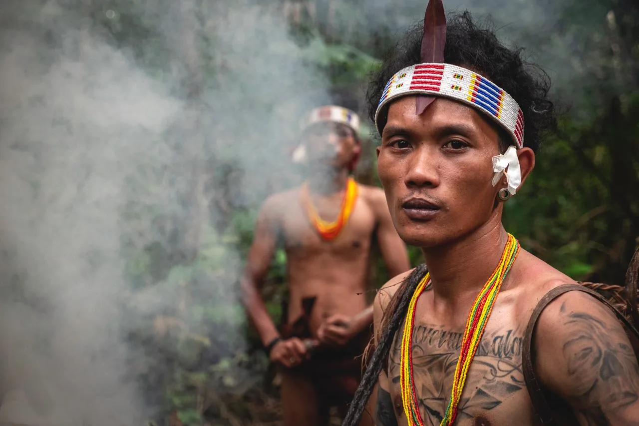 A Mentawai host standing in the rainforest